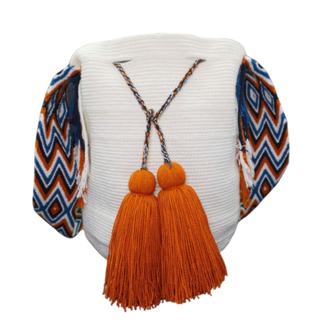 White Mochila with Patterned Handle. The wayuu bag also has 2 tassels in burnt orange