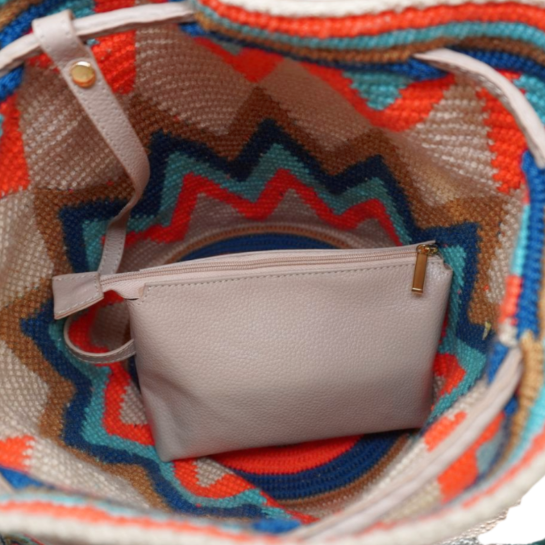 Cream Leather Crochet Bag with Zigzag Pattern. the image shows the smaller leather bag inside of the wayuu bag
